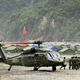 Chinese troops carry a survivor off a S-70 helicopter at a makeshift helipad in Yingxiu, southwest China’s Sichuan province on May 29, 2008.